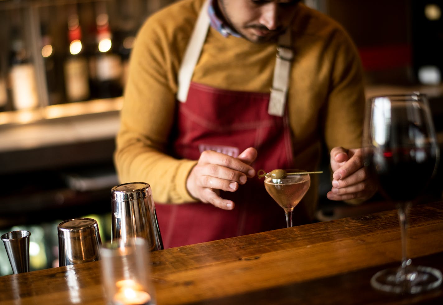 Terzo bartender Bradley Sylte, of Minneapolis, placed an olive on top of a dirty martini for a patron at the bar Thursday night. ] Aaron Lavinsky ¥ aaron.lavinsky@startribune.com Since Minneapolis passed a new liquor law allowing neighborhood restaurants to serve hard alcohol, more than 30 have applied. We photograph the bar scene at Terzo, one of the restaurants taking advantage of the law, on Thursday, May 16, 2019 in Minneapolis, Minn.