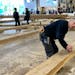 Peter Henrikson, 61, a timber framer from Minnesota, measures a beam, part of the new roof of the Notre Dame cathedral de Paris, Thursday, May, 25, 20