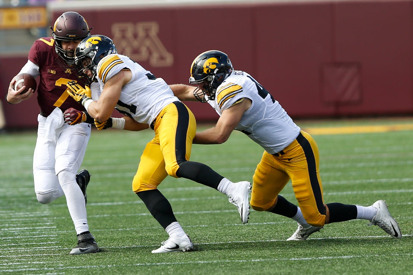 Gophers quarterback Mitch Leidner was pushed across the field by Iowa linebacker Aaron Mends on Saturday. Iowa won 14-7.