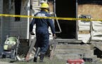 Erie Bureau of Fire Inspector Mark Polanski helps investigate a fatal fire at 1248 West 11th St. in Erie, Pa, on Sunday, Aug. 11, 2019. Authorities sa