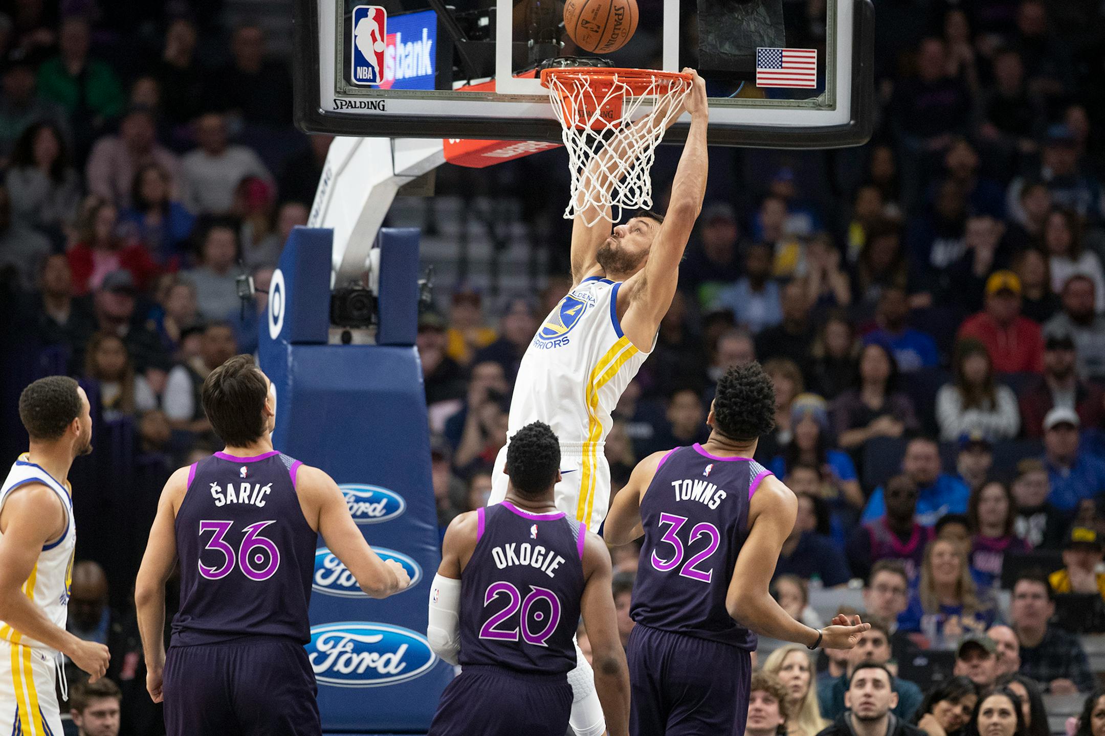 The Warriors' Andrew Bogut dunked over the Timberwolves' defense in Golden State's 117-107 victory at Target Center on Tuesday.