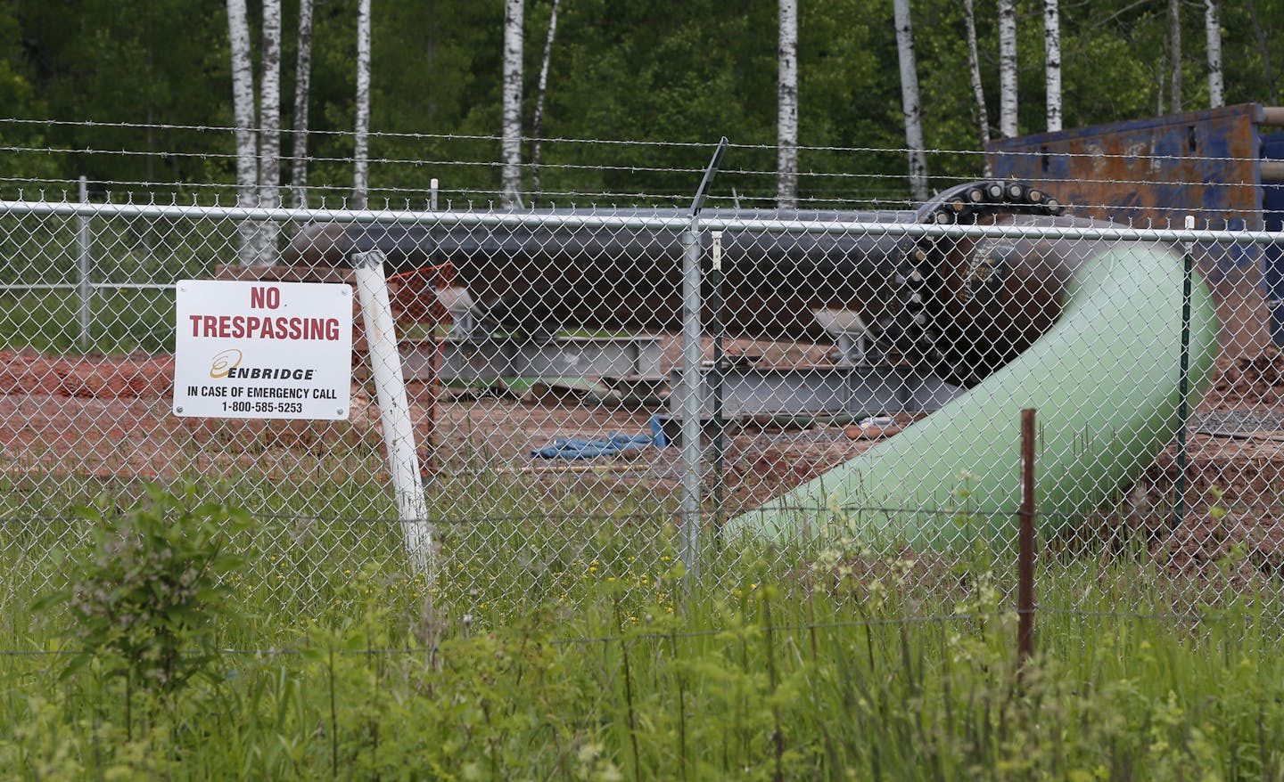 A "No Trespassing" sign is visible in 2018 at a Enbridge Energy pipeline drilling pad along a rail line that traces the Minnesota-Wisconsin border south of Jay Cooke State Park in Minnesota. (AP Photo/Jim Mone)