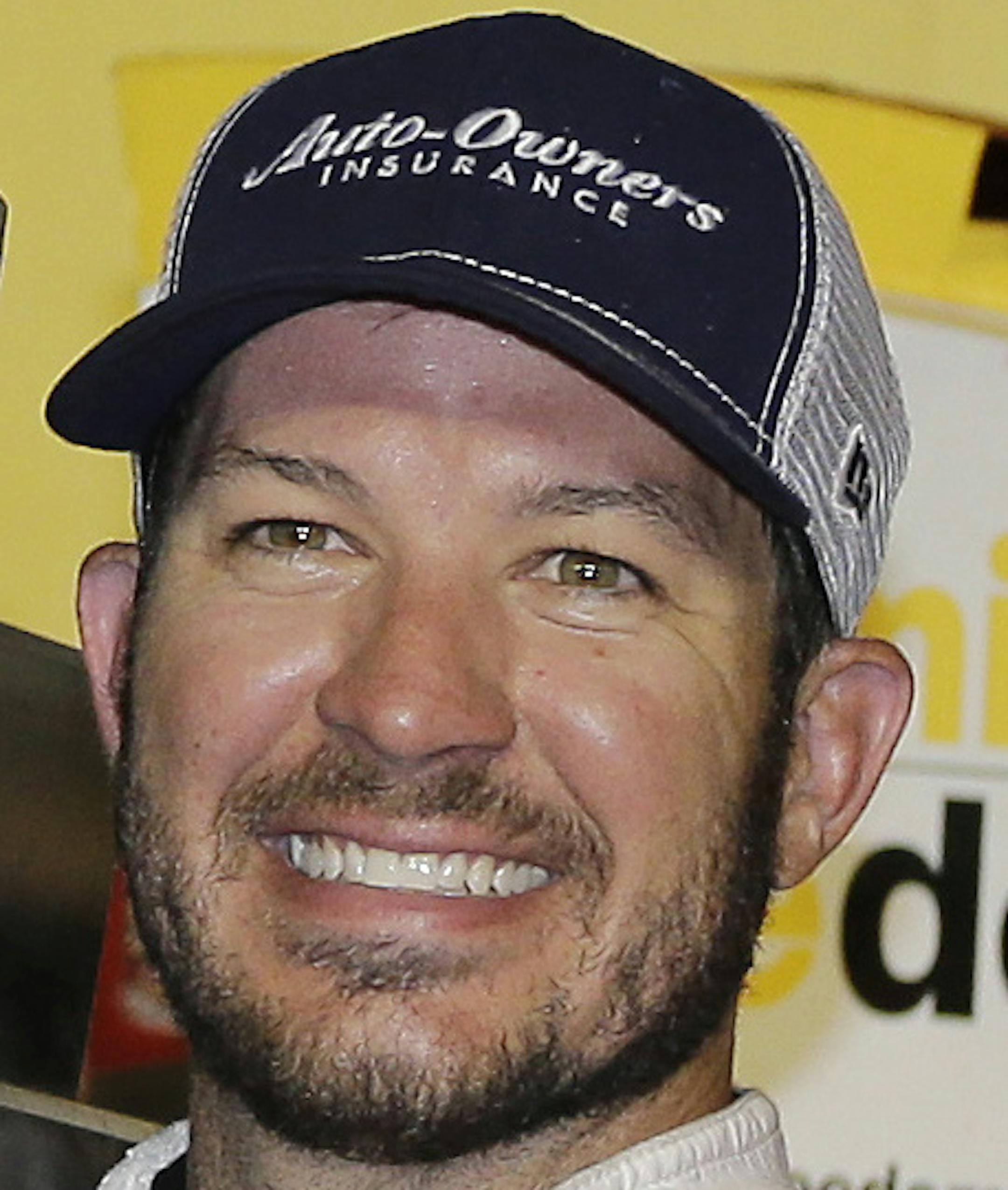 Martin Truex Jr. holds his trophy in Victory Lane after winning the NASCAR Sprint Cup Series auto race at Darlington Raceway Sunday, Sept. 4, 2016, in Darlington, S.C. (AP Photo/Terry Renna)