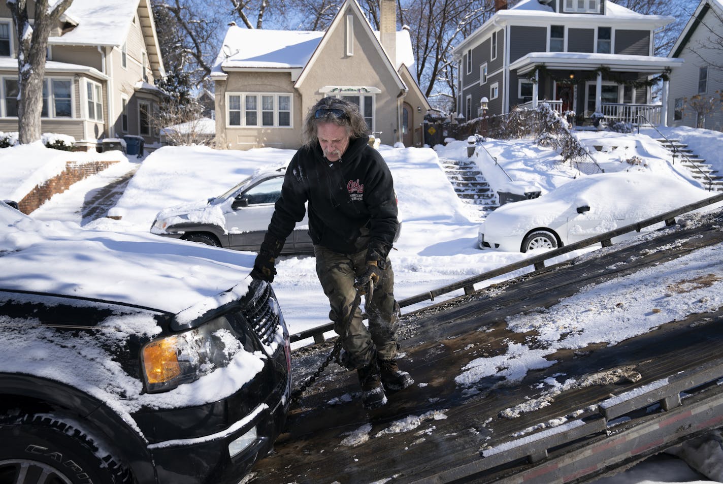 Kerry Brendmoen of Corky's Towing hitched a vehicle to his tow flatbed that was parked on wrong snow emergency side of Beard Avenue South in Minneapolis, Minn., on Friday, February 8, 2019. The snow plow was waiting for that side of the street to be cleared so it could finish plowing the road. ] RENEE JONES SCHNEIDER &#xa5; renee.jones@startribune.com