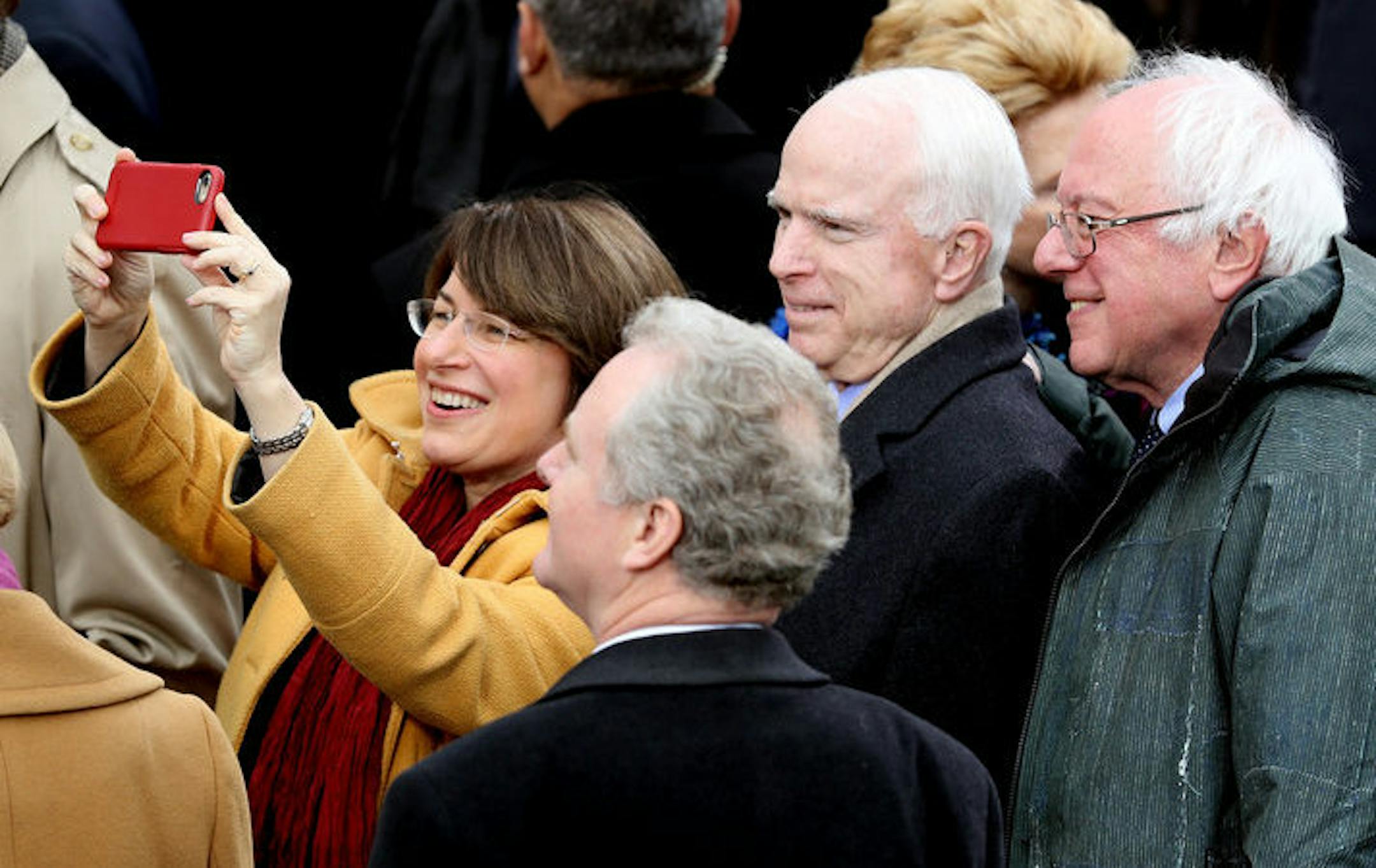 Sen. Amy Klobuchar takes a selfie with Sen. John McCain and Sen. Bernie Sanders in front of the U.S. Capitol at President Trump's inauguration. (Photo by Joe Raedle/Getty Images)
