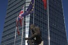 The British and EU flags fly together in the business district of Madrid, Spain, Tuesday, June 21, 2016. British voters head to the polls on Thursday 