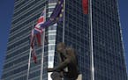 The British and EU flags fly together in the business district of Madrid, Spain, Tuesday, June 21, 2016. British voters head to the polls on Thursday 