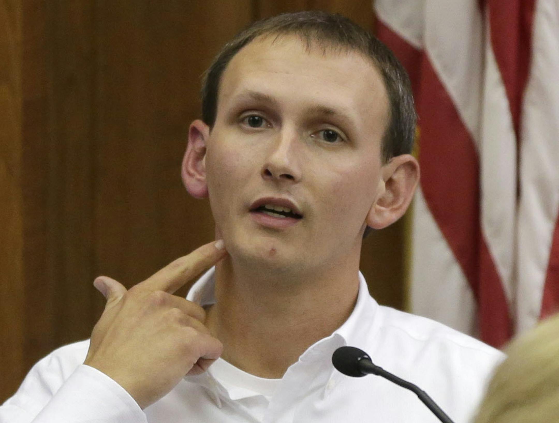 In this Oct. 5, 2015 photo, Milwaukee Police Officer Bryan Norberg describes being shot while testifying in court during the Badger Guns trial in a Milwaukee. Norberg and former Officer Graham Kunisch brought a lawsuit against a Wisconsin gun shop that they say has sold hundreds of weapons used in crimes. The potentially precedent-setting case hinges on whether the gun shop owners should be financially responsible for a crime committed with a weapon purchased at their store. (Mike De Sisti/Milwa