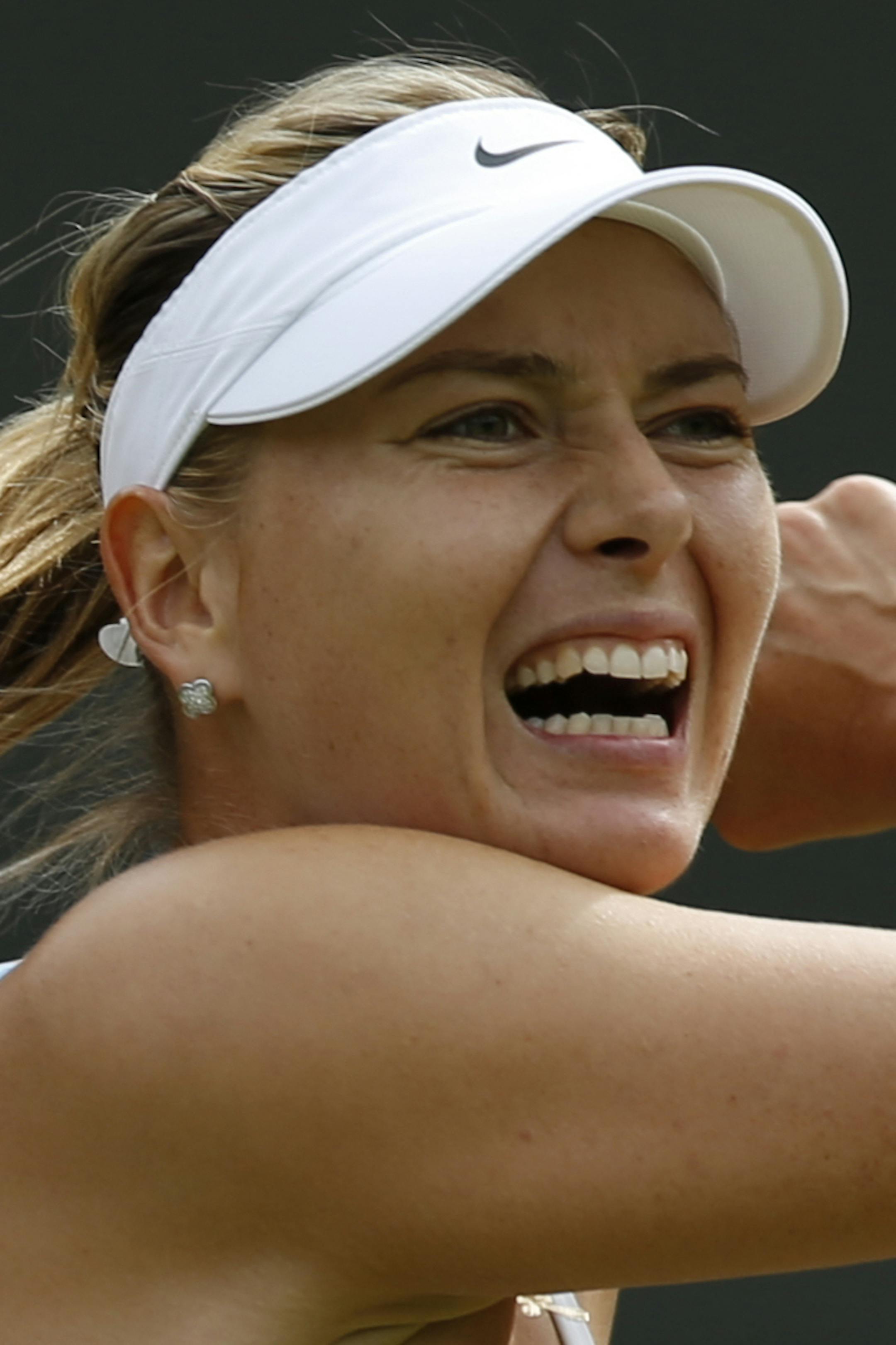 ADVANCE FOR WEEKEND EDITIONS, AUG. 29-30 - FILE - In this July 3, 2015, file photo, Maria Sharapova returns a ball to Irina-Camelia Begu during their singles match at the All England Lawn Tennis Championships in Wimbledon, London. Sharapova is seeded third for the U.S. Open tennis tournament. (AP Photo/Pavel Golovkin, File)