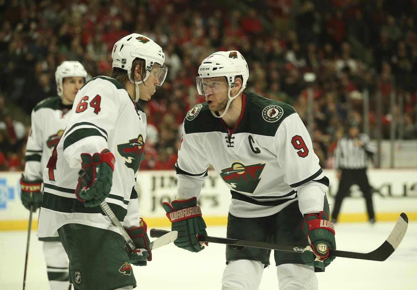 Minnesota Wild center Mikko Koivu (9) conferred with Mikael Granlund.