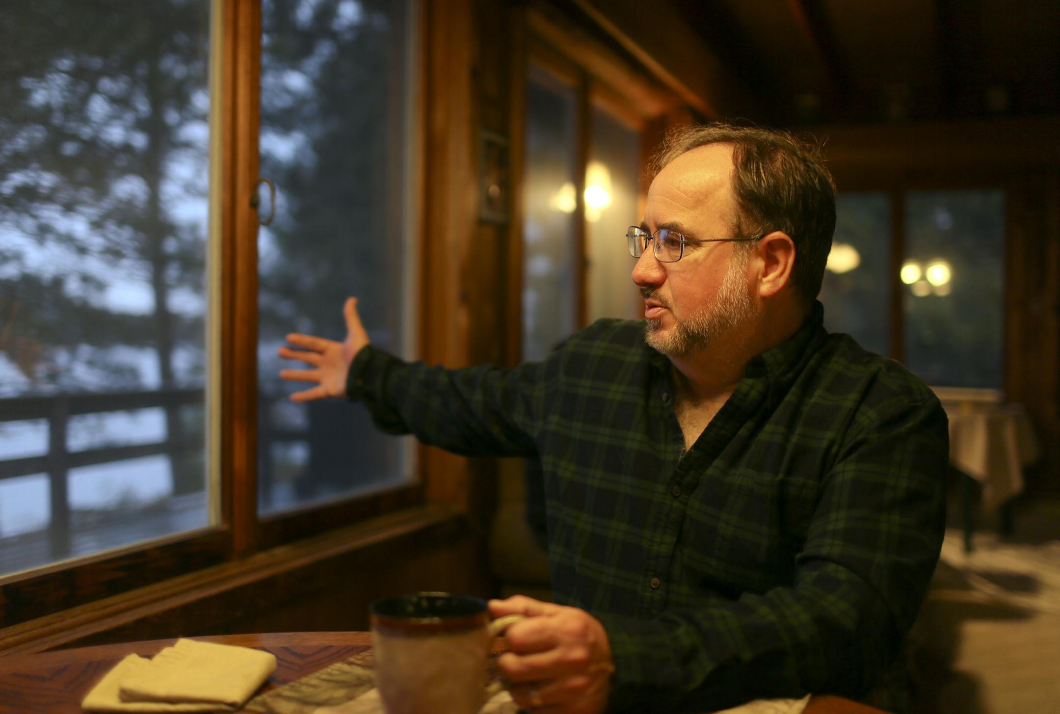Al Cambronne gestures toward the wildlife habitat outside his rural home. "Hunting is our best tool for keeping deer numbers in check," he says.