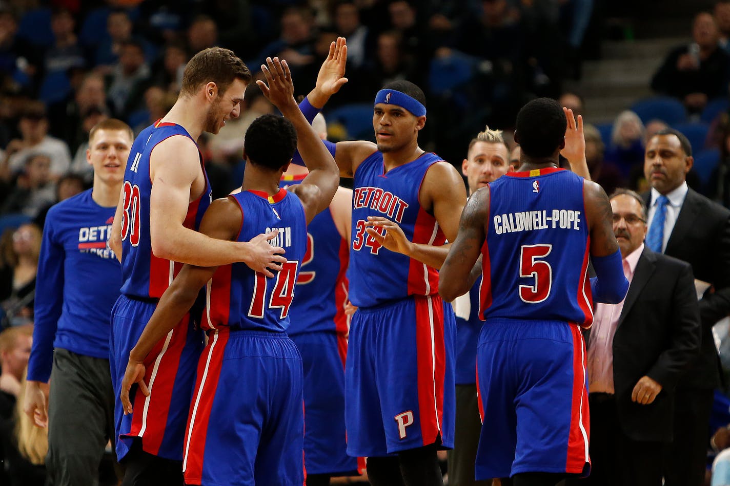 Detroit Pistons forwards Jon Leuer (30) and Tobias Harris (34) congratulate teammate guard Ish Smith