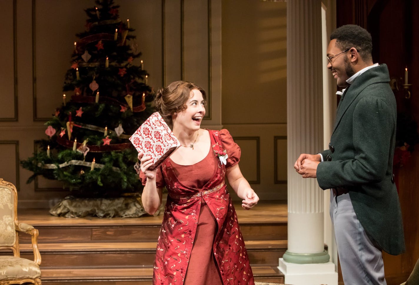 Mary Bennet (Christian Bardin, left) tackles both gift-giving and romance -- with, perhaps, Arthur de Bourgh (JuCoby Johnson, right) -- in "Miss Bennet: Christmas at Pemberley" at Jungle Theater.