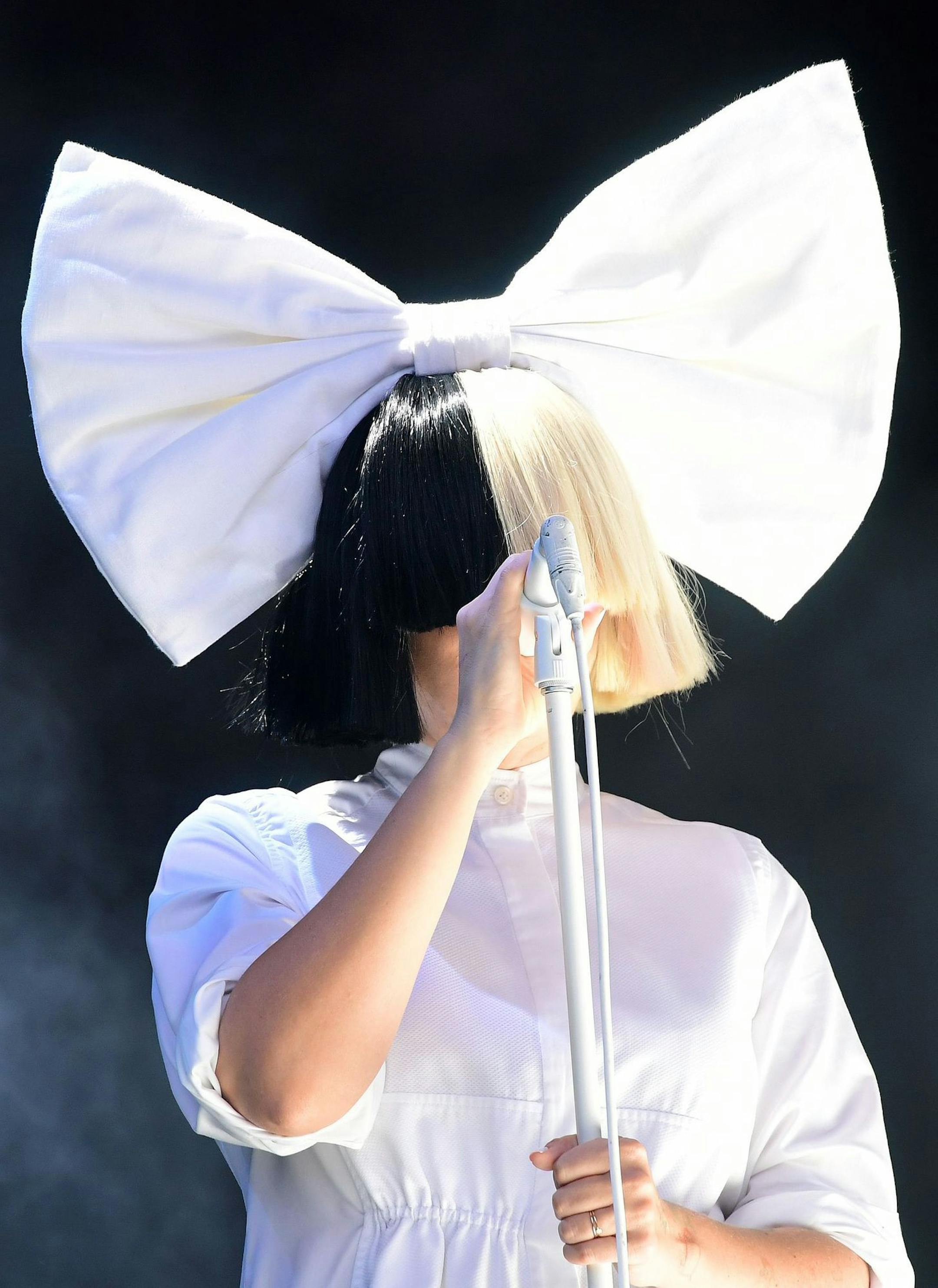 Sia performs during the V Festival at Hylands Park in Chelmsford, England, Saturday, Aug. 20, 2016. (Ian West/PA via AP)