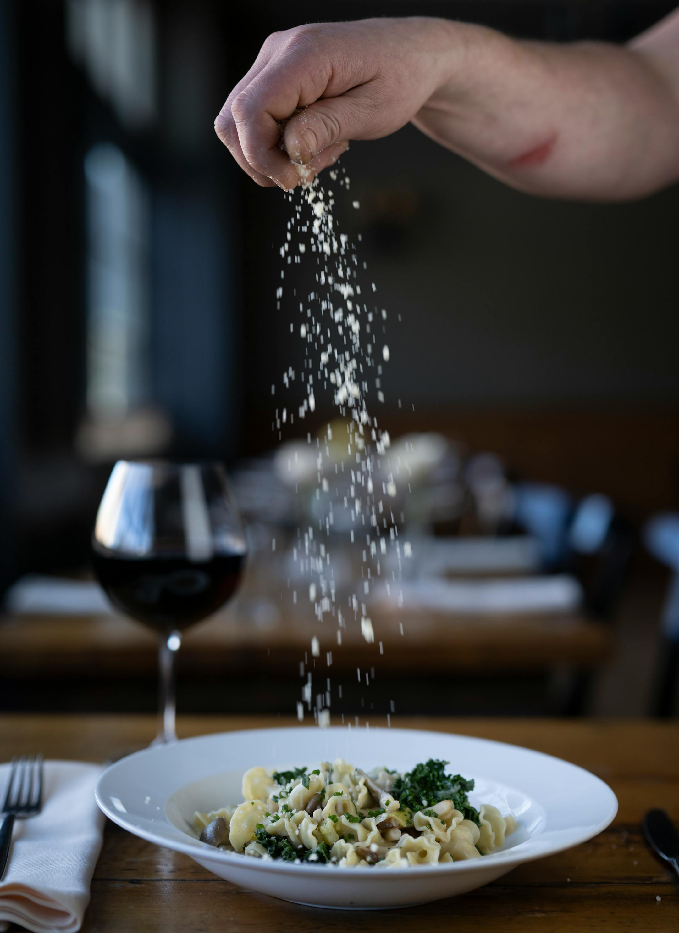 Grana Padano cheese is sprinkled onto the campanelle with mixed mushrooms, leeks, kale at The Kenwood.