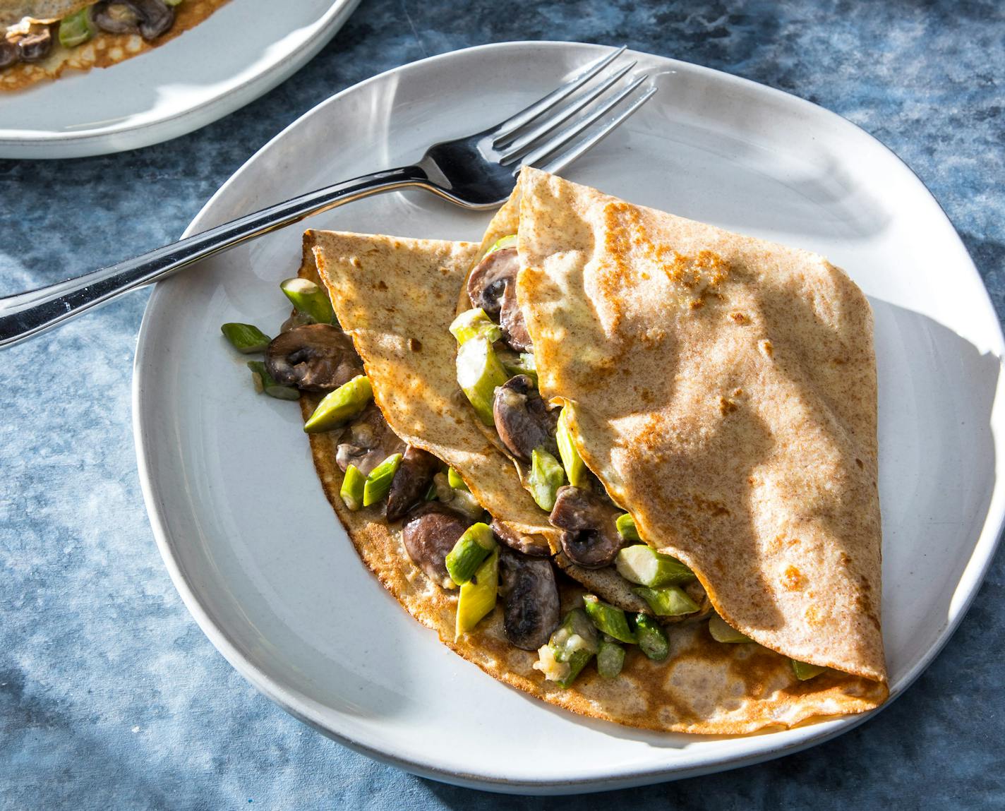 Whole-Wheat Crepes with Creamy Sautéed Mushrooms and Asparagus from "The Savory Baker" by America's Test Kitchen. Credit: Carl Tremblay