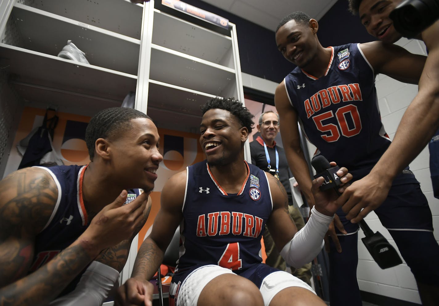 Auburn guard J'Von McCormick joked with teammates Malik Dunbar and Austin Wiley during media availability in the team locker room on Thursday