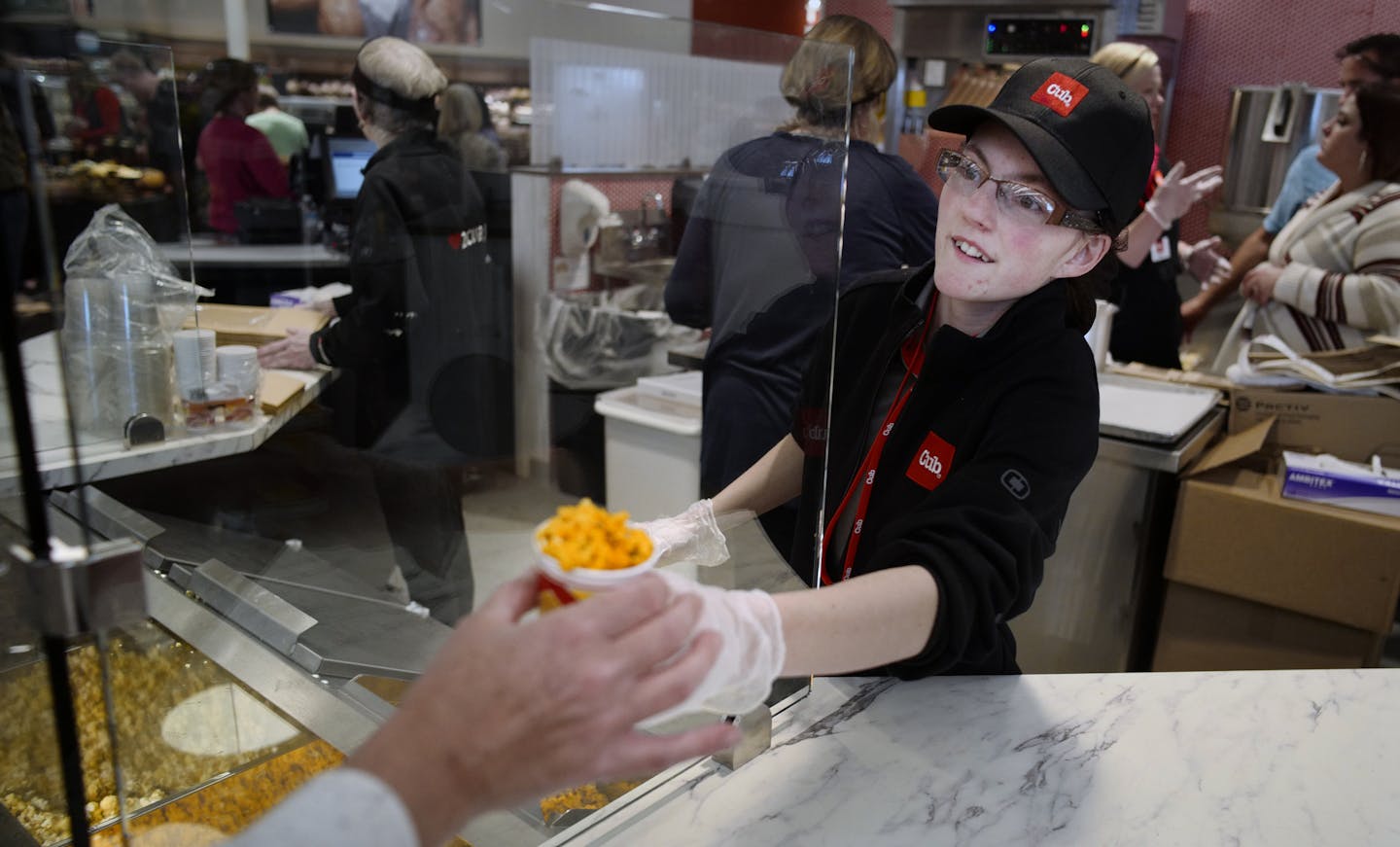 Constance Metkowski handed out Cheese popcorn samples.]Chad Ferguson, president of Cub's retail west division and Anne Dament, sr vp of retail, merchandise and marketing, will give Ewoldt a tour of the new store. Richard Tsong-Taatarii/Richard.tsong-taatarii@startribune.com