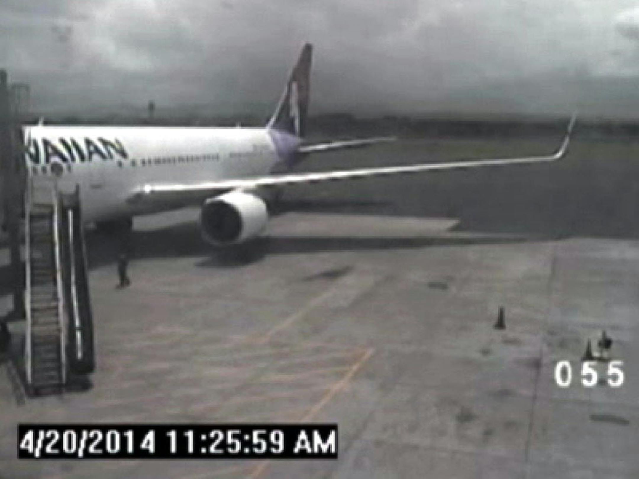 A screen shot of surveillance video that shows a California teen, left, after hopping from a jet's wheel well in Maui, Hawaii on April 20, 2014.