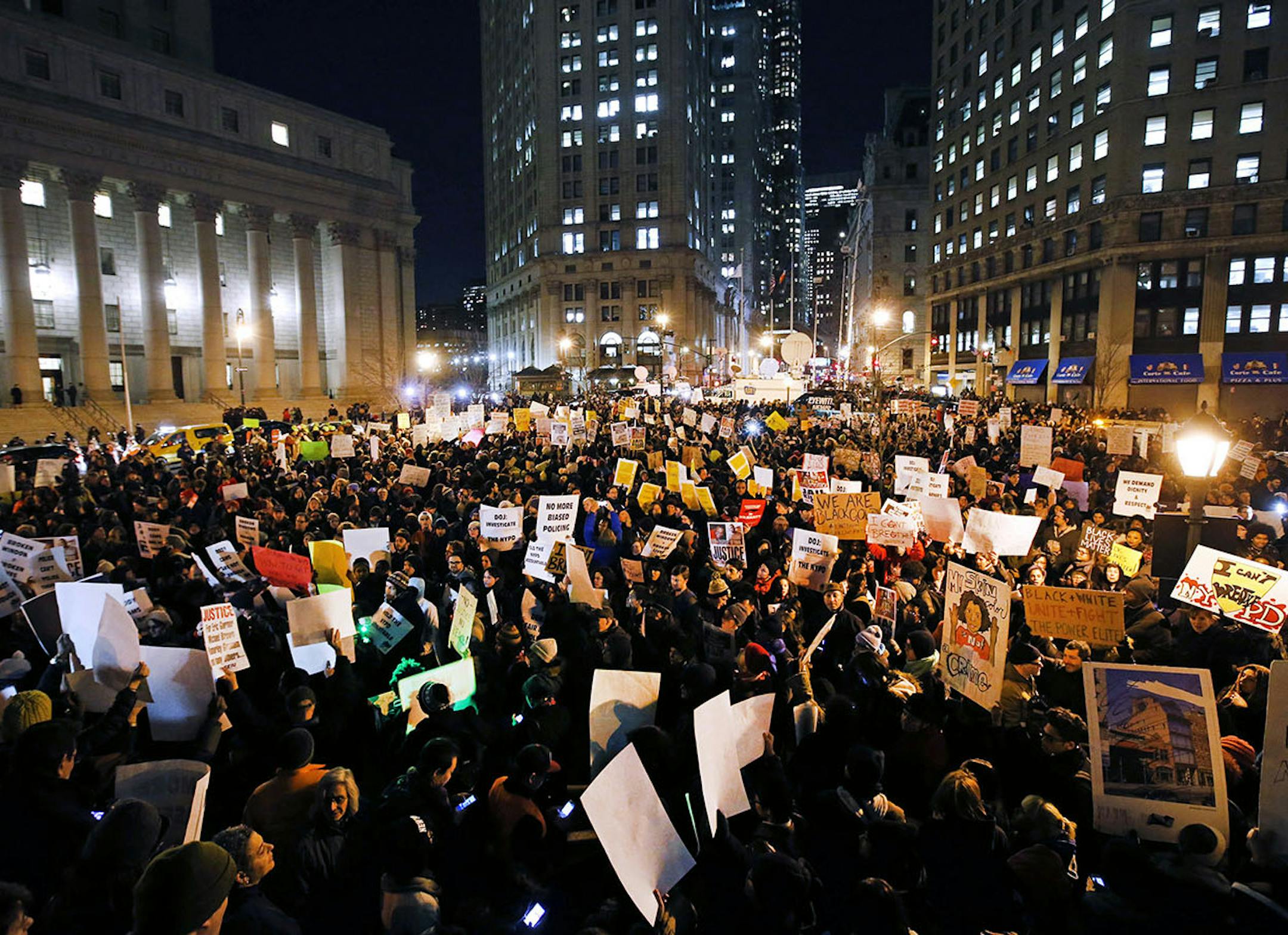 Protesters rally against a grand jury's decision not to indict the police officer involved in the death of Eric Garner in Foley Square, Thursday, Dec. 4, 2014, in New York. A grand jury cleared a white New York City police officer Wednesday in the videotaped chokehold death of Garner, an unarmed black man, who had been stopped on suspicion of selling loose, untaxed cigarettes. (AP Photo/Jason DeCrow) ORG XMIT: MIN2014120418301601