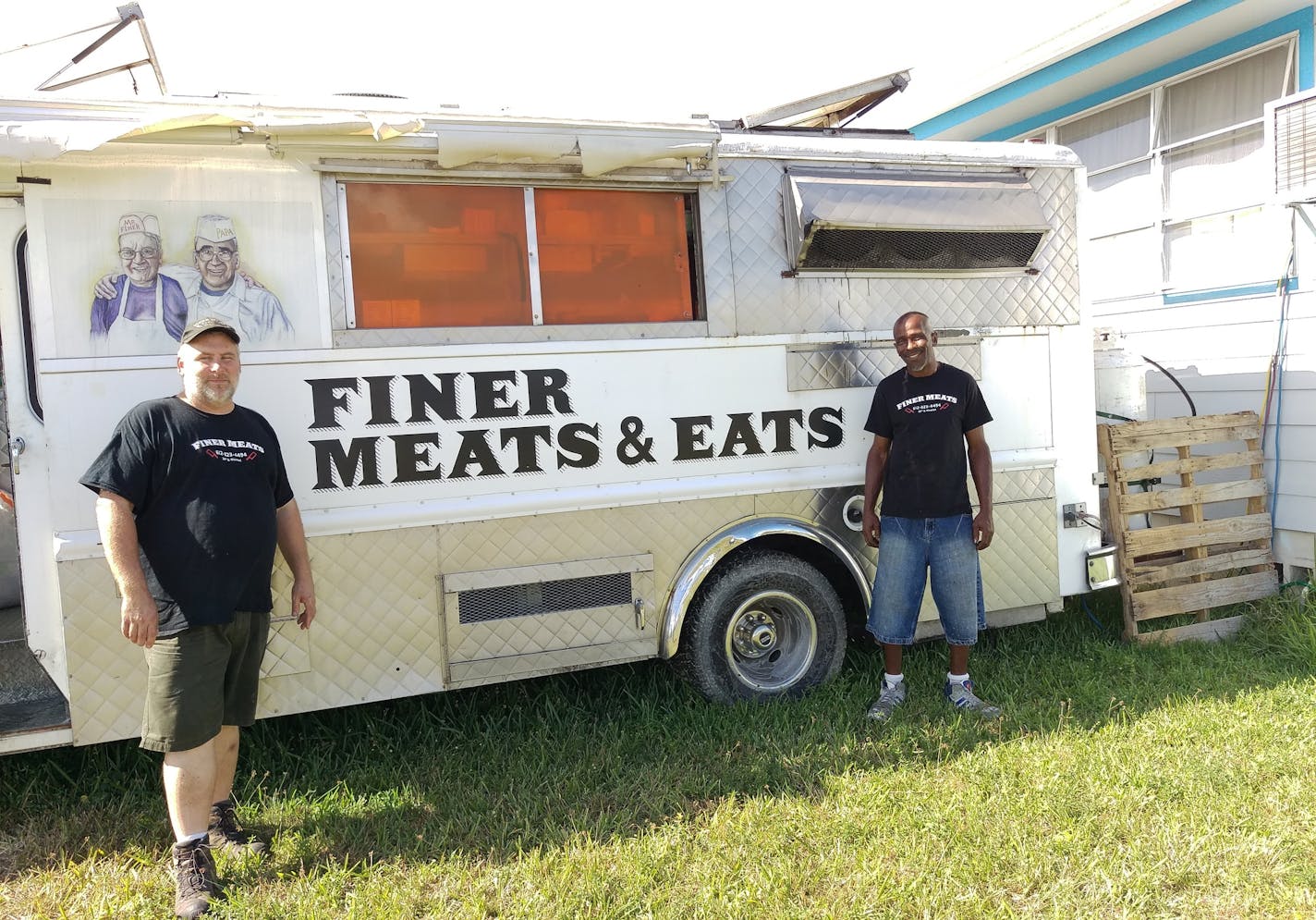 Doug Meyer, left, and cook David Wade stand outside Meyer's Finer Meats & Eats food truck in Everglades City, Fla. Meyer brought the truck down there to help feed victims of Hurricane Irma.