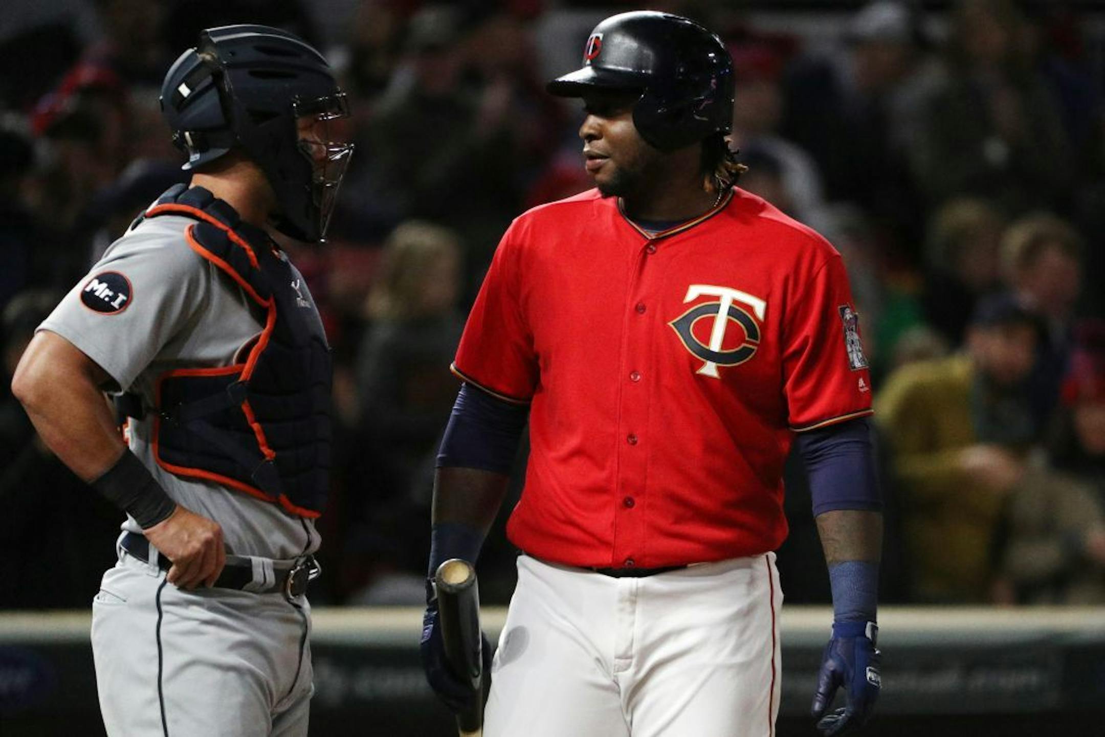 Minnesota Twins third baseman Miguel Sano (22) talked with Detroit Tigers catcher James McCann (34) as he went to bat in the seventh inning.