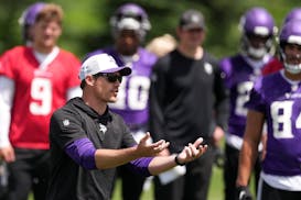 Minnesota Vikings quarterback J.J. McCarthy (9) watches as head coach Kevin O'Connell explains a drill during organized team activities two weeks ago.