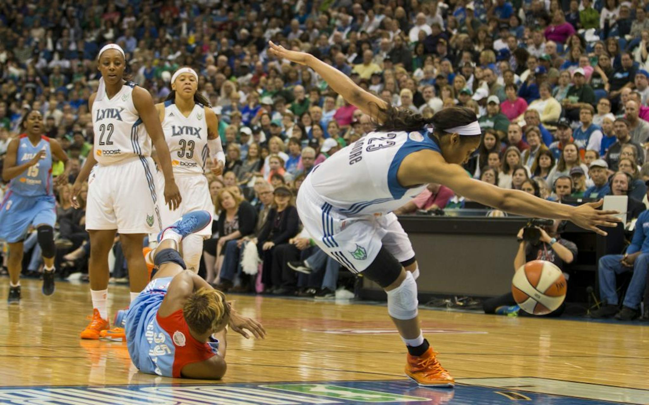 Maya Moore of the Lynx burst through Angel McCoughtry of the Atlanta Dream.