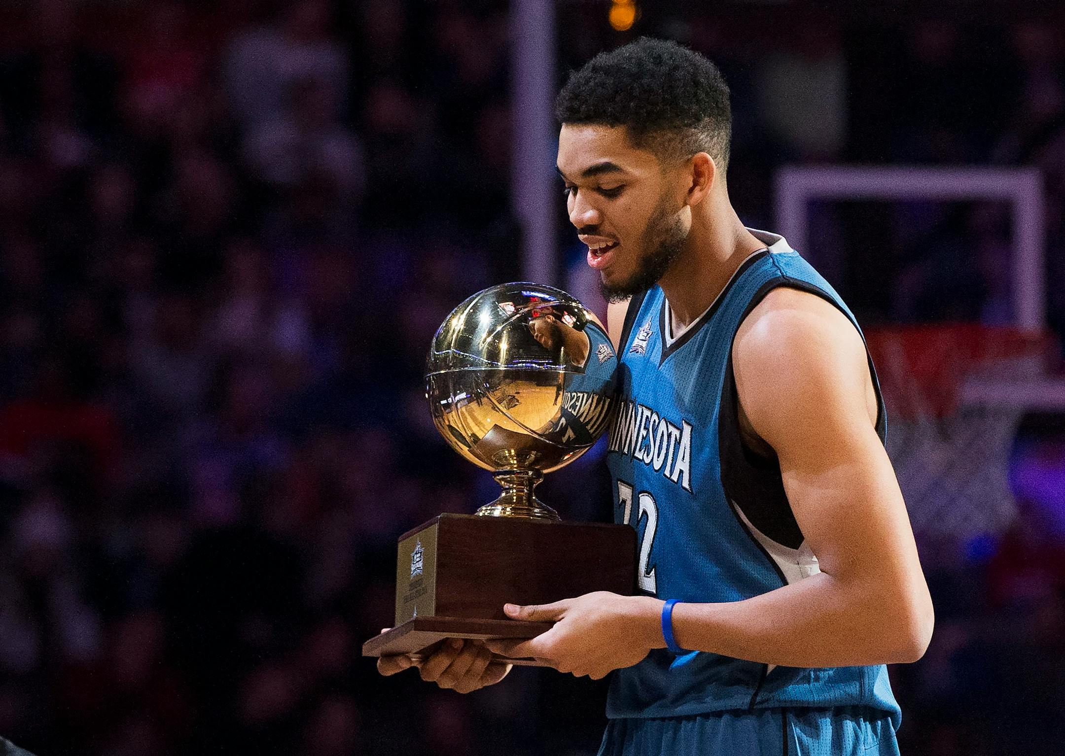 Minnesota Timberwolves' Karl-Anthony Towns (32) hold the trophy after winning the front court NBA all-star skills competition in Toronto on Saturday, Feb. 13, 2016.