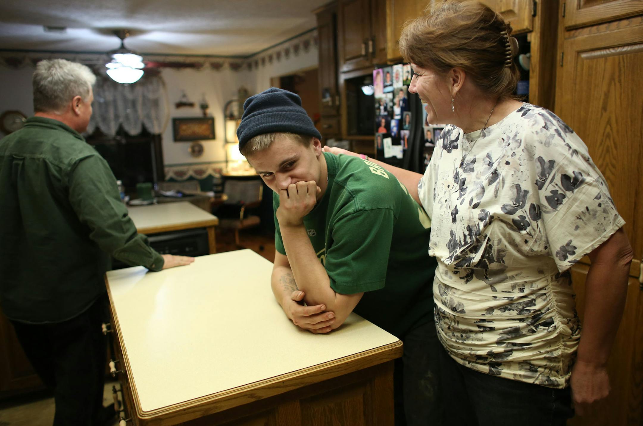 Jackie Mayer chatted with her son, Jimmy Mayer, in their kitchen in Cedar, in Anoka County. After surviving an overdose, Jimmy has been clean for four months.