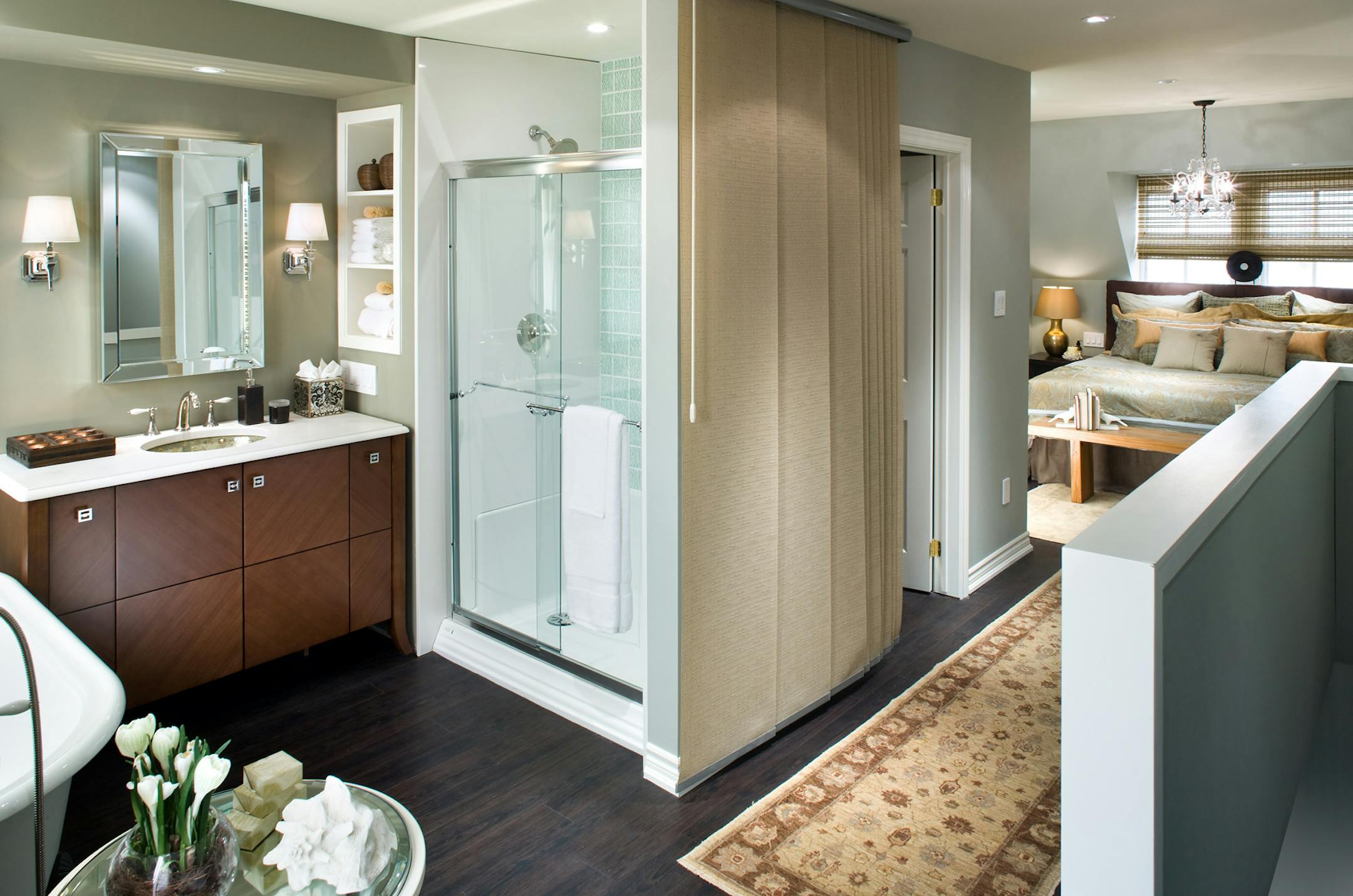 The third-floor bedroom and bath are bright, airy and a loft-like, emphasizing cool colors, quartz and tile surfaces and a soothing palette.