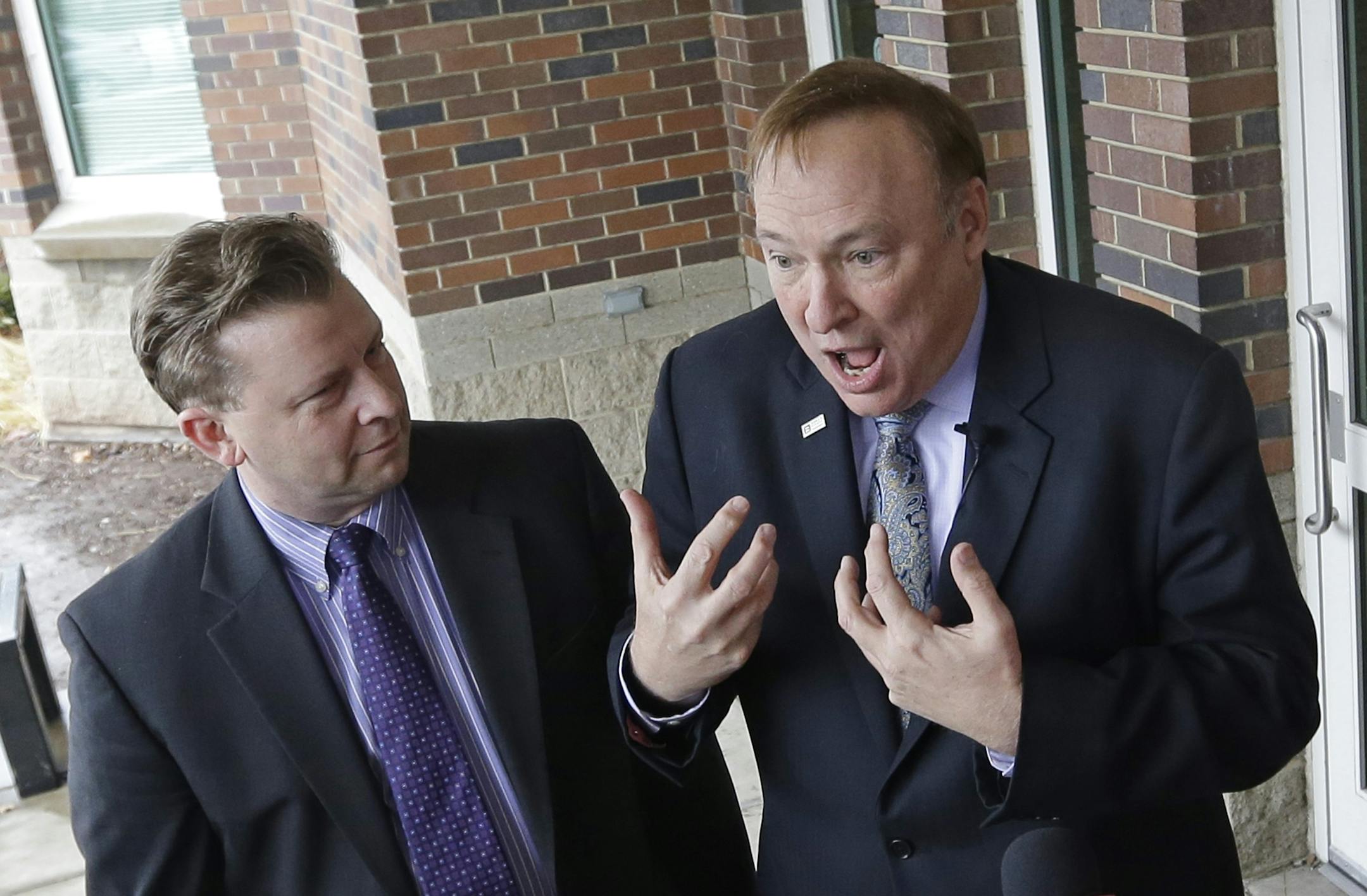 Sen. Todd Weiler, R-Woods Cross, left, and Sen. Jim Dabakis, D-Salt Lake City, speak to reporters in the doorway of Uintah Elementary School before stoping in for school lunch Thursday, Jan. 30, 2014, in Salt Lake City. A school district apologized Thursday to outraged parents after about 30 students at a Salt Lake City school had their lunches thrown out because of outstanding balances on their food accounts. Salt Lake City School District spokesman Jason Olsen said the district is investigatin
