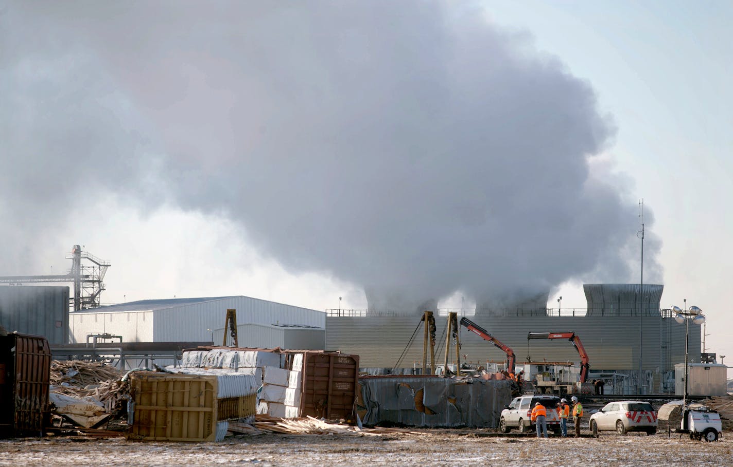 Crews clean up on Friday, Nov. 14, 2014, after two BNSF trains derailed just west of Casselton, N.D., on Thursday. BNSF Railway officials said it appears that a broken rail caused a derailment which affected 21 cars of an eastbound train carrying lumber and paper and 12 cars of a westbound train carrying empty oil tankers. There was no fire or hazardous waste spilled and no one was hurt. (AP Photo/Bruce Crummy)