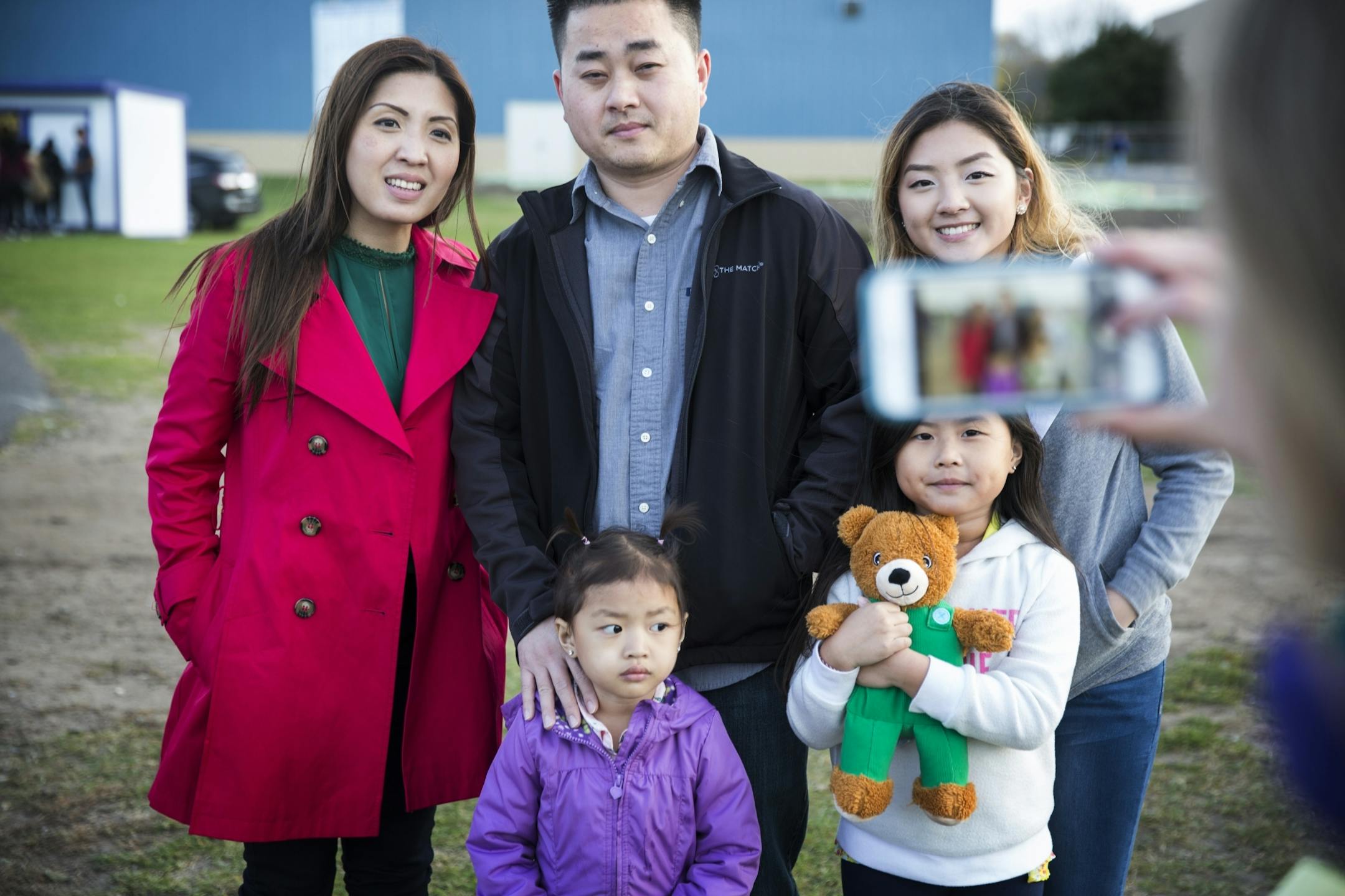 Homecoming court member Jade Yang, right, poses for a photo with her father Chia Yang, mother Zoua Her and little sisters Ivy, 3, and Rainie, 7.