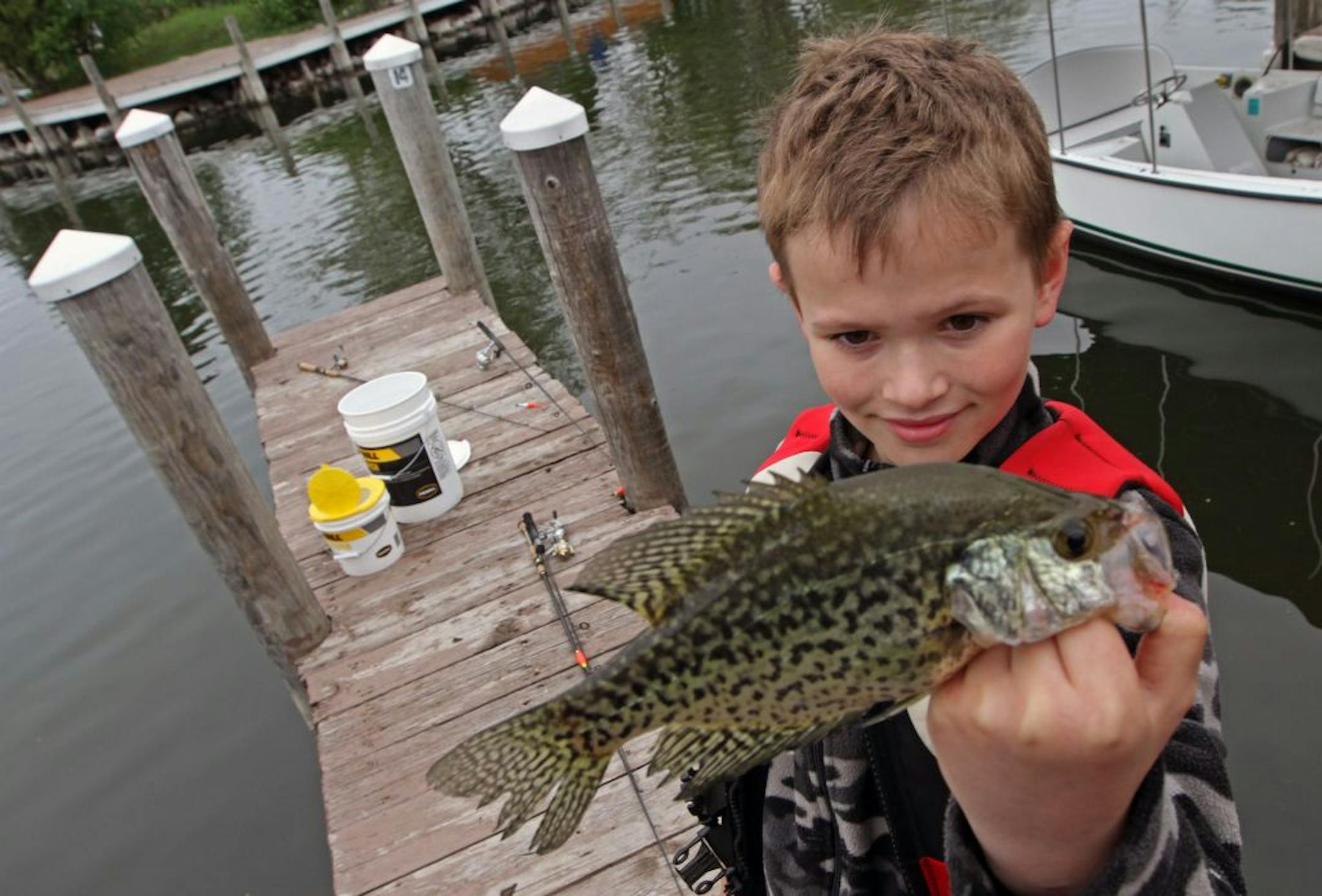 Noah Goodrich, age-9 from Minnetonka, held up a fish he caught while fishing off the docks at Lord Fletchers, in the Minnesota Bound's Crappie Contest on Lake Minnetonka. Under sponsorship by Ron Schara's Minnesota Bound television show, the contest pre-registered over 1000 anglers for the event based out of Lord Fletcher's on Lake Minnetonka, 5/5/12.