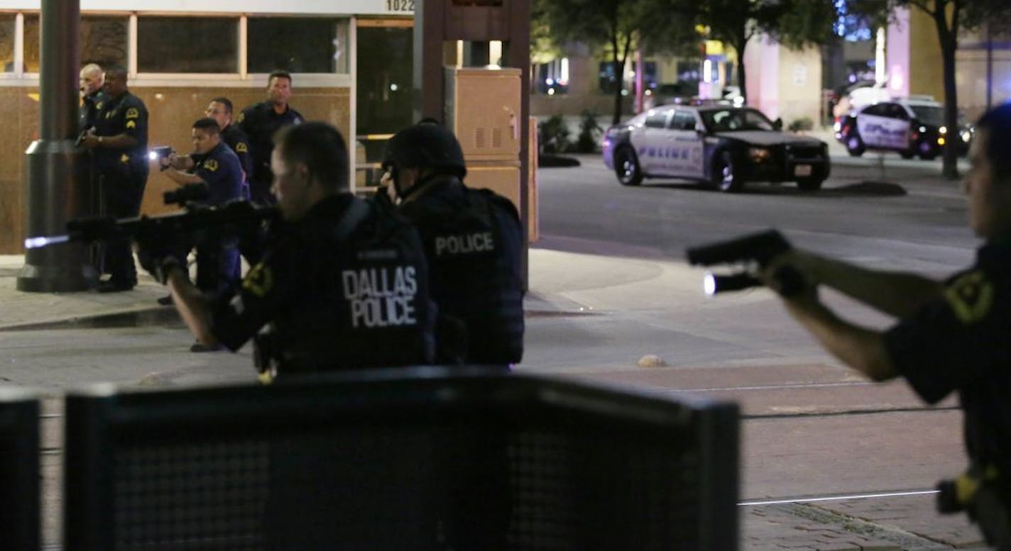 FILE - In this July 7, 2016, file photo, Dallas police move to detain a driver after several police officers were shot in downtown Dallas when a sniper opened fire at a Black Lives Matter protest. Only hours after the ambush that killed five Dallas law enforcement officers, mental health experts began thinking ahead, searching for ways to ease the long-term effects of the attack on the men and women who patrol the nation�s ninth-largest city. A year after the ambush, Dallas officers are still gr