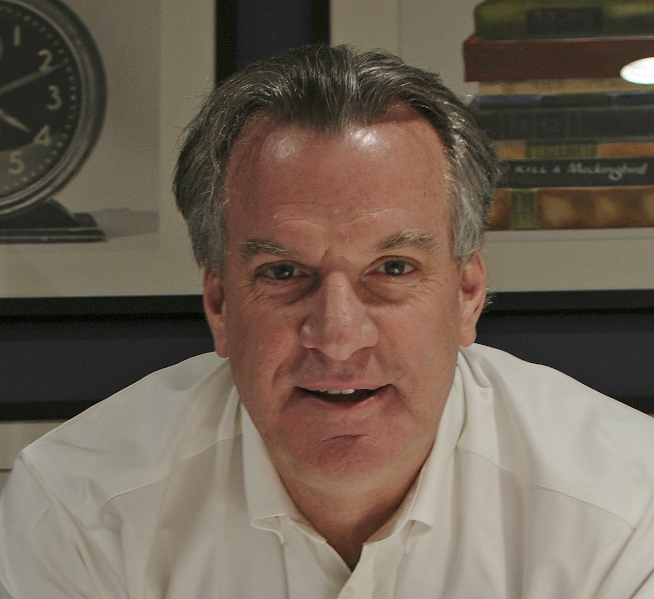 Kelly Doran is a veteran Minneapolis real estate developer and one of his latest projects is the 412 Lofts at the corner of 4th St SE and 12th Ave SE in Dinkytown, he posed for this portrait on Wednesday November 2, 2011. The picture was made in a common room in the main lobby of the building. The art on the wall he bought before the project and by coincidence the time on the alarm clock is 4:12. ] Richard Sennott/Star Tribune. Richard.Sennott@startribune.com Minneapolis Minn. Tuesday 11/2/11) *