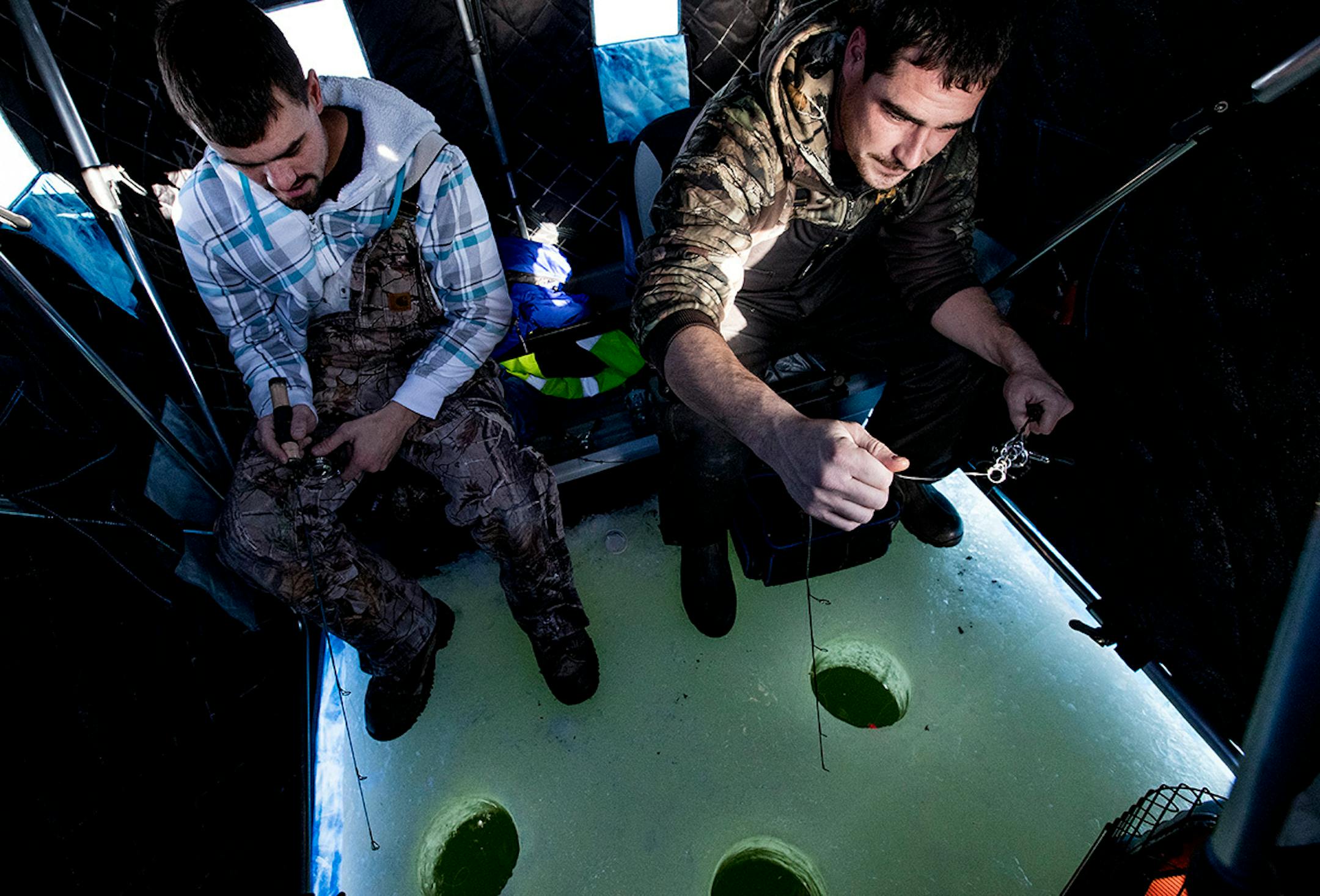 Austin Klein, 30, of Brooklyn Center, left, and Dan Welsh, 29, of Maple Grove ice fished Jan. 4 in an insulated portable ice house on Medicine Lake in Plymouth. ] CARLOS GONZALEZ cgonzalez@startribune.com - January 4, 2017, Plymouth, MN, Ice Fishing on Medicine Lake