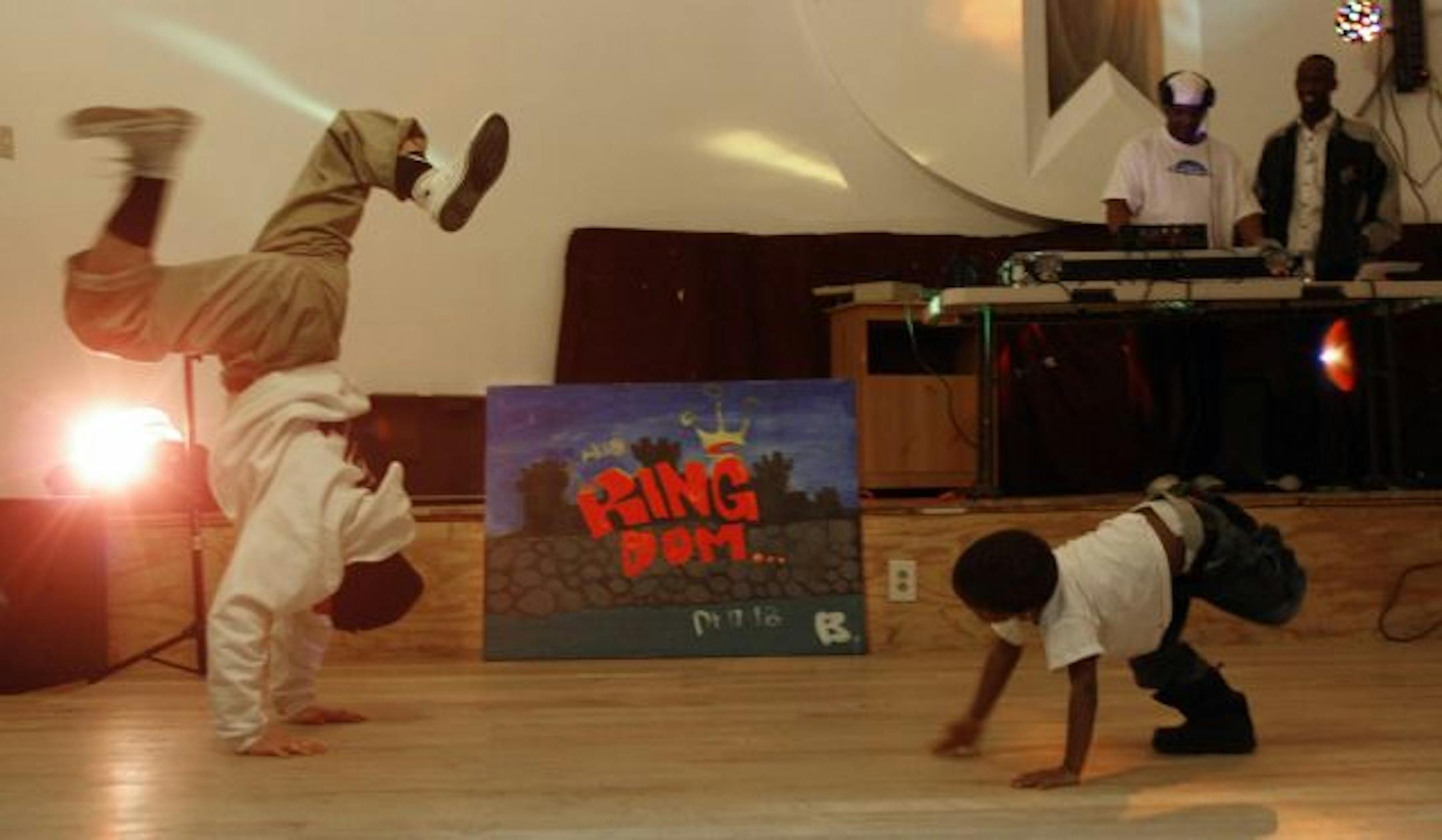 Before the service at Urban Jerusalem in Minneapolis, a break dancer who calls himself BBoy Abide, left, warmed up with Priest, the 3-year-old son of church founders Stacey and Tryenyse Jones.