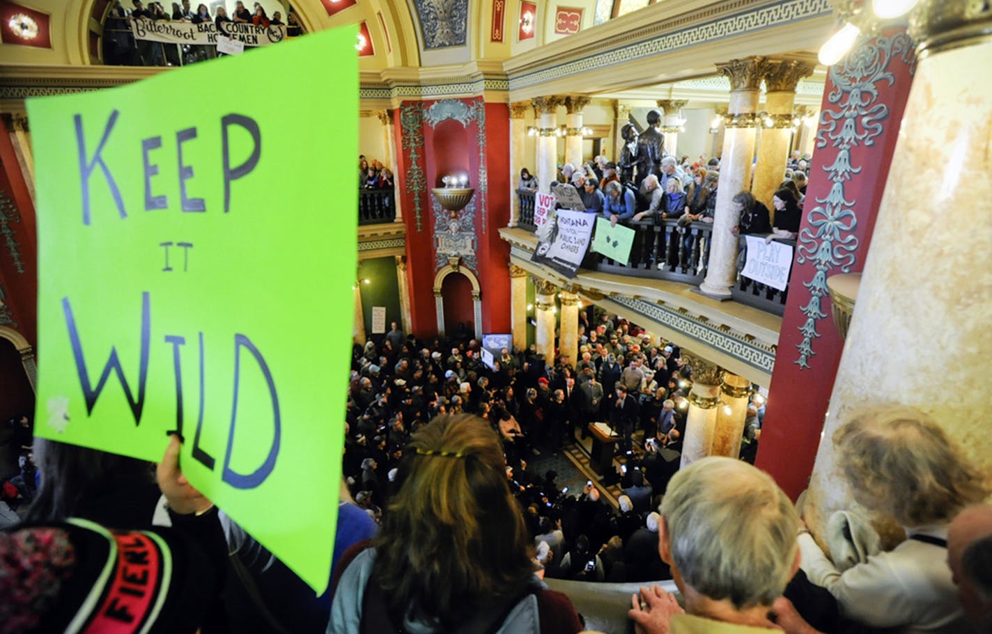 About 2,000 people filled the Montana Capitol for a rally to urge state and federal lawmakers to protect public lands, Friday, Jan. 11, 2019, in Helena, Mont. (Thom Bridge/Independent Record via AP) ORG XMIT: MERe29f83f344097818ec96a829fcb42