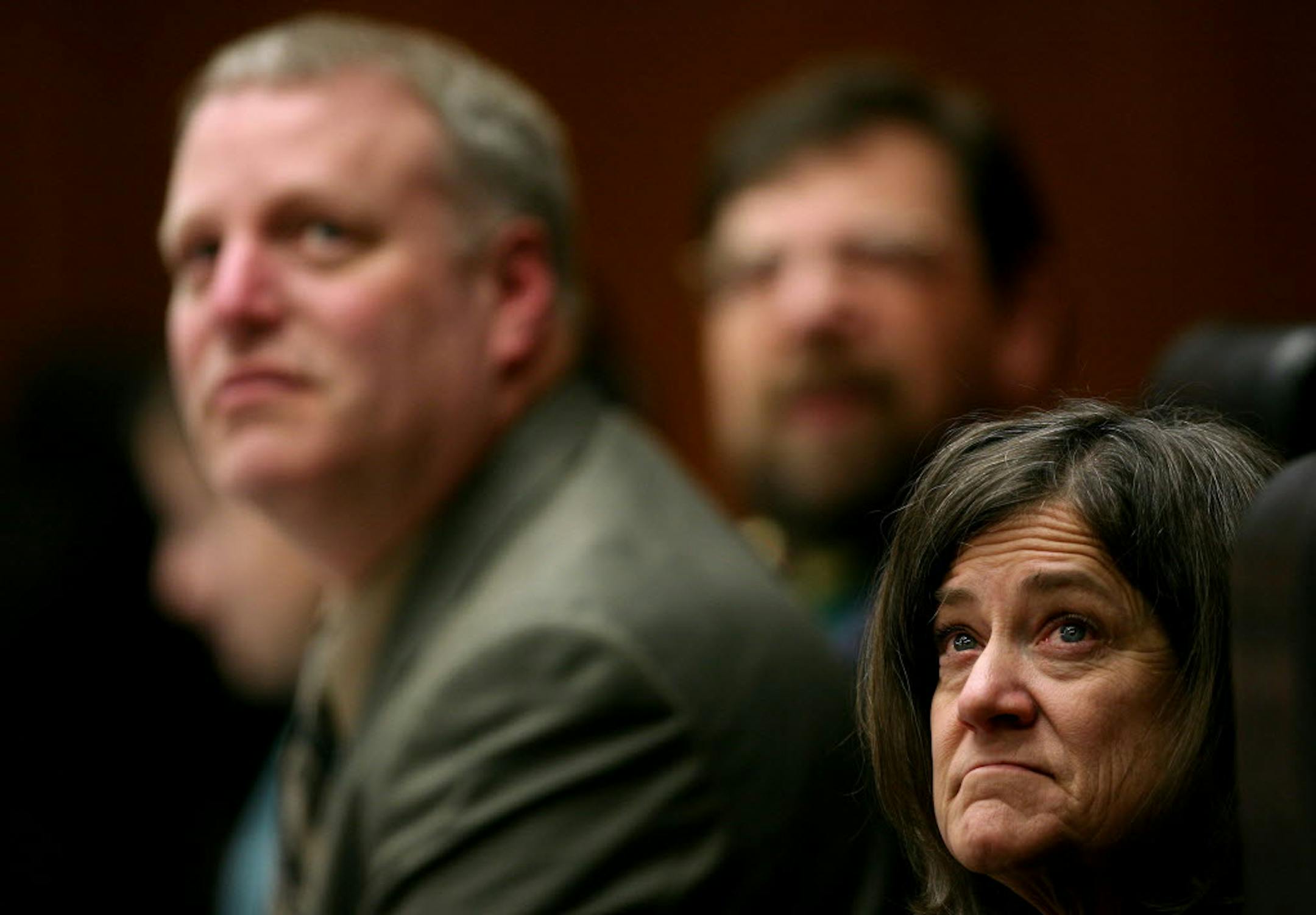 Elections administrator Michele Mcnulty, right, Jim Gelbmann (deputy secretary of state) and Bert Black looked at ballots on a monitor as the state Canvassing Board meet Thursday.