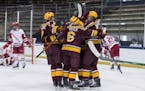 Minnesota players celebrate a goal against Wisconsin during the championship game of the Big Ten men's hockey tournament Tuesday, March 16, 2021, in S