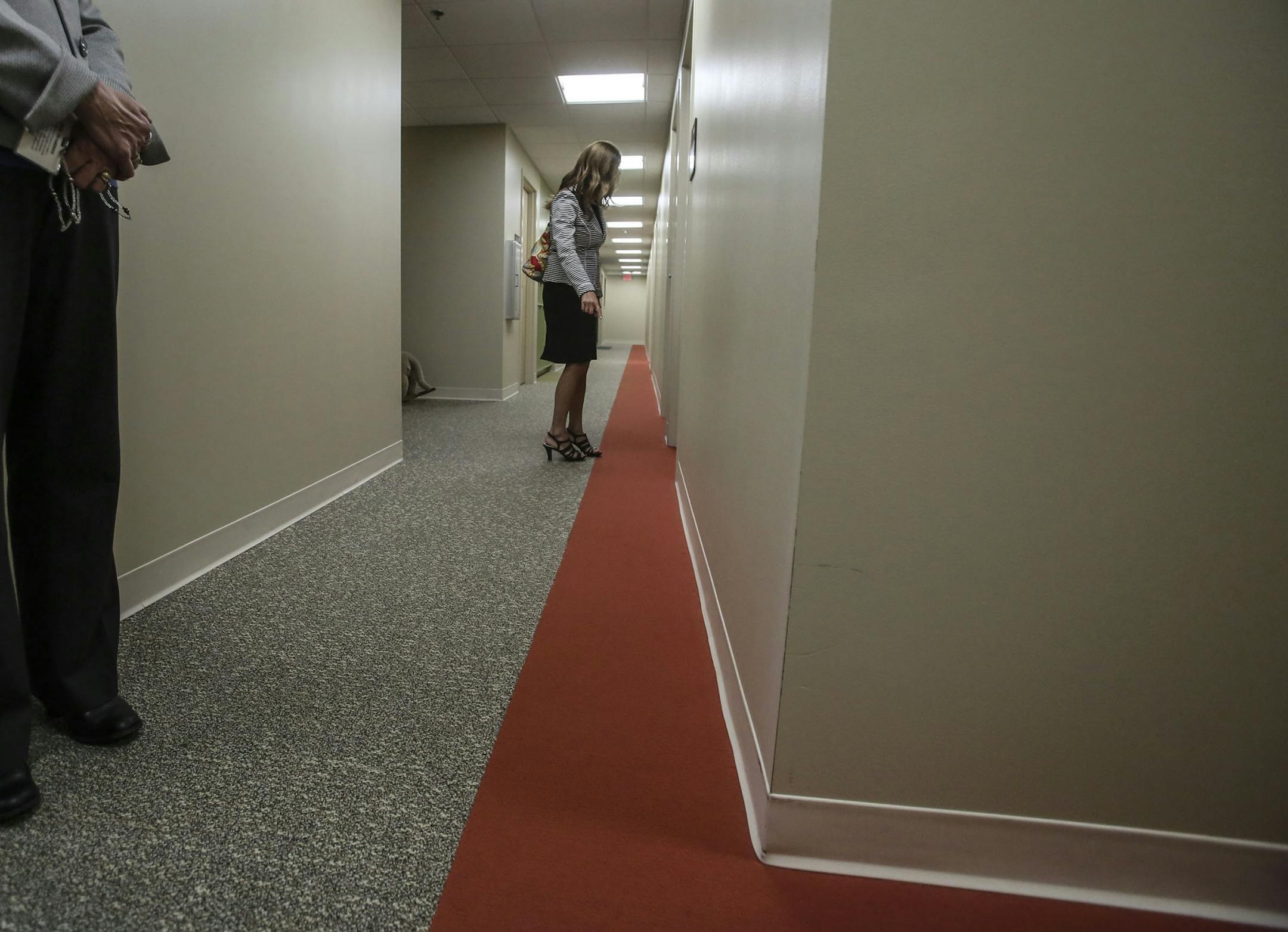 Local designer A.J. Paron-Wildes, whose son is autistic, had helped to design the space at Fraser Eden Prairie and seen Wednesday, Oct. 23, 2014, in Eden Prairie, MN. Here, Paron-Wildes is seen in a Fraser hallway where the carpeting appears seamless and offers a colored pathway to guide students.