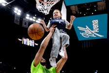 Kameron Anderson, 4, got some help from his dad Kyle Anderson of the Timberwolves before tonight's game in Denver.