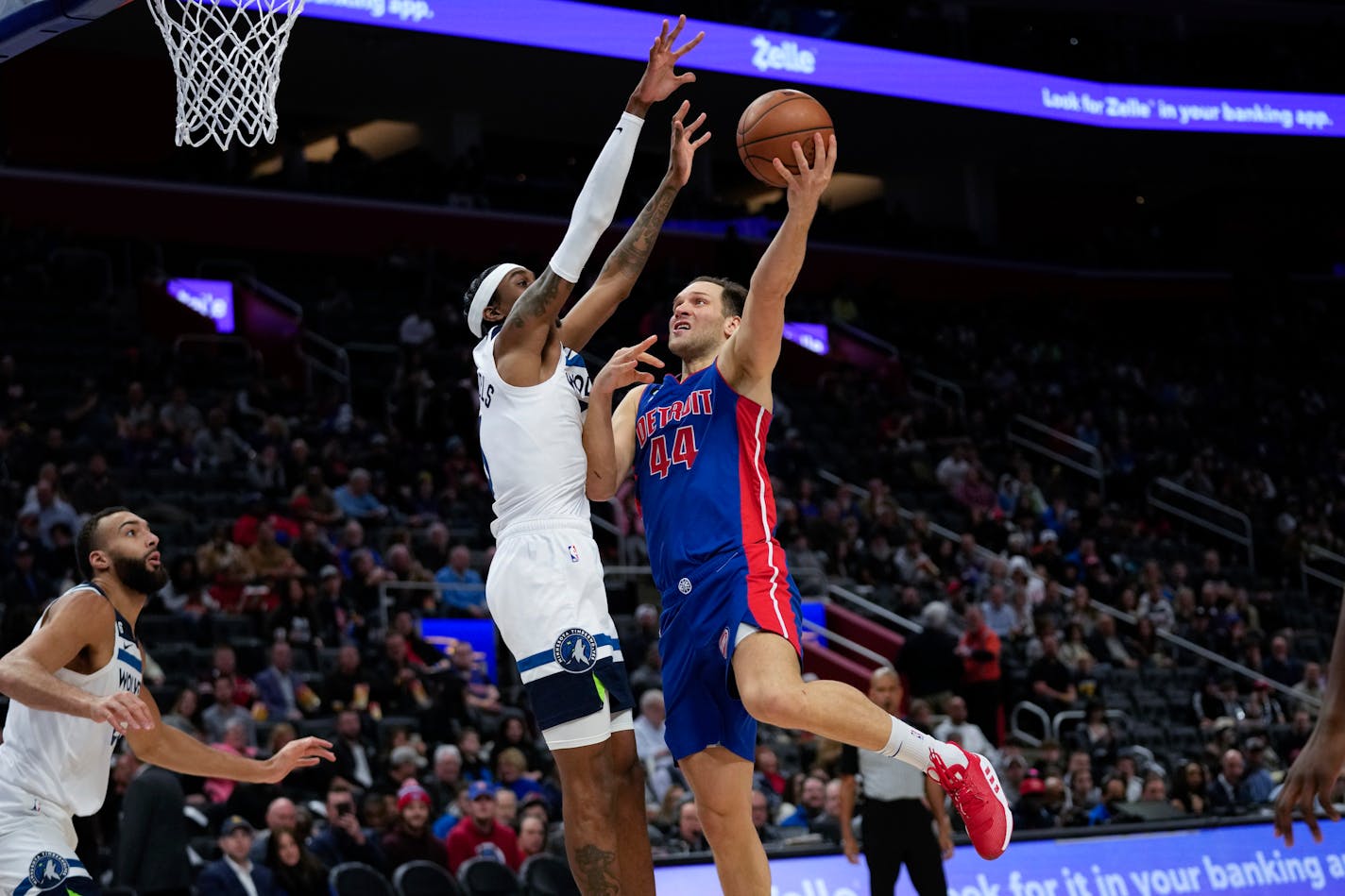 Detroit Pistons forward Bojan Bogdanovic (44) drives on Minnesota Timberwolves guard Jordan McLaughlin (6) in the first half of an NBA basketball game in Detroit, Wednesday, Jan. 11, 2023. (AP Photo/Paul Sancya)