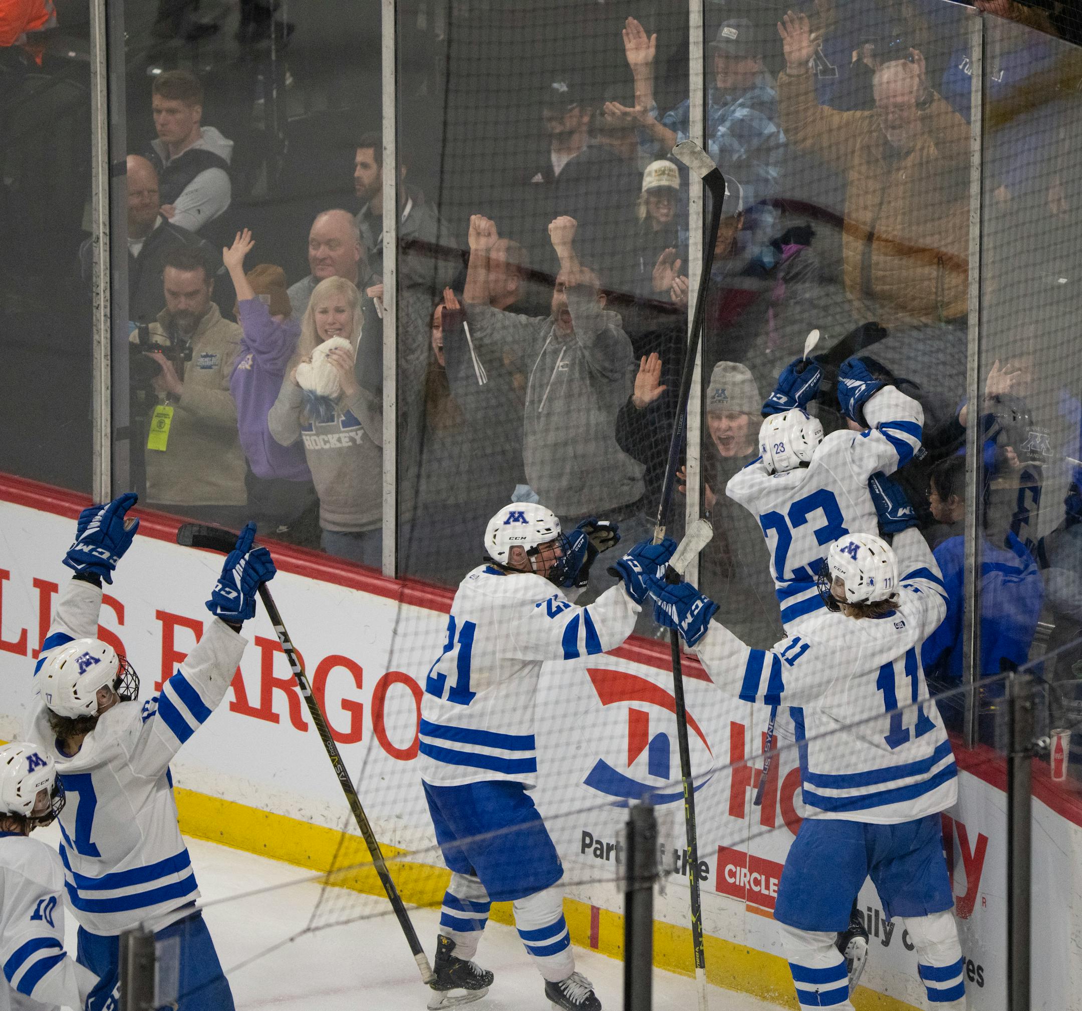 Minnetonka Skippers defenseman John Stout (23) leapt against the glass to celebrate his game winning goal in overtime.