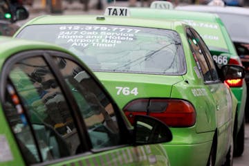 Most taxi dowtown taxi cabs had credit card logos posted on their vehicles in downtown Minneapolis, Friday, January 13, 2012. Minneapolis City Council