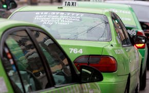 Most taxi dowtown taxi cabs had credit card logos posted on their vehicles in downtown Minneapolis, Friday, January 13, 2012. Minneapolis City Council