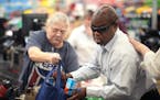 James Sloan, an employee at the Hy-Vee store in New Hope, bagged groceries for a customer. Sloan, who is blind, is a mainstay at the store, a communit