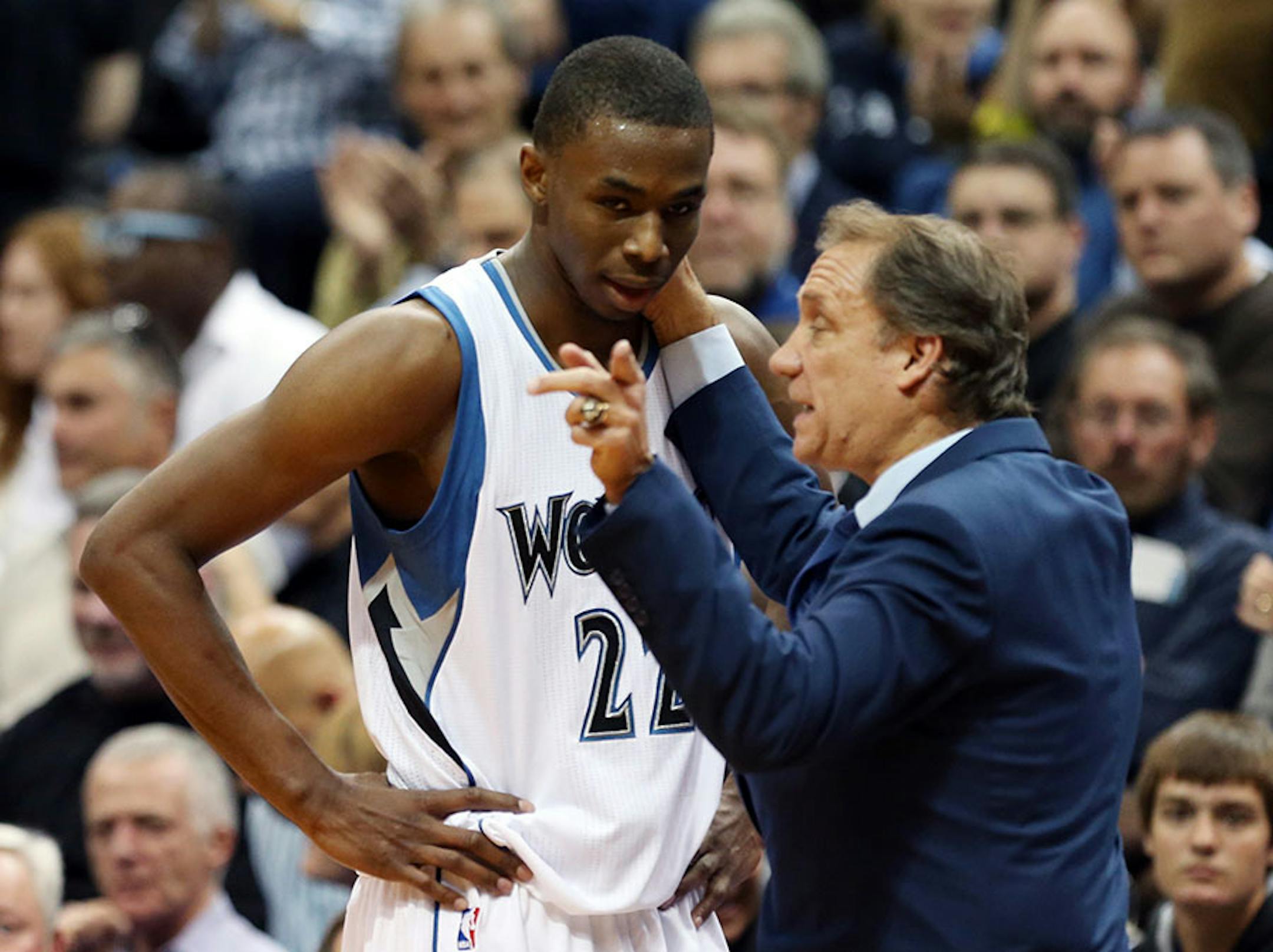 Minnesota Timberwolves head coach Flip Saunders gives pointers to rookie Andrew Wiggins as he headed to the bench in the second half of an NBA basketball game, Thursday, Oct. 30, 2014, in Minneapolis. The Timberwolves won 97-91.